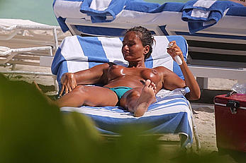 Eda Taspinar sunbathing topless