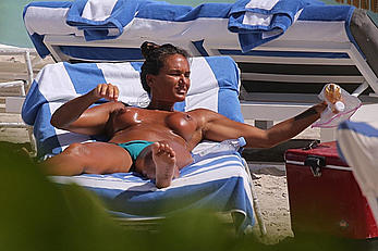 Eda Taspinar sunbathing topless