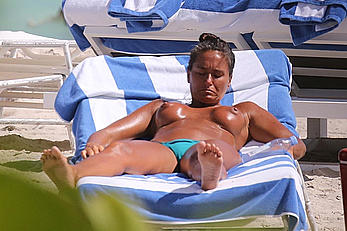 Eda Taspinar sunbathing topless