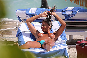 Eda Taspinar sunbathing topless