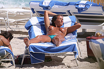 Eda Taspinar sunbathing topless