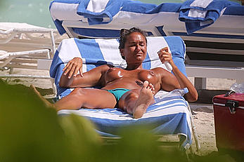 Eda Taspinar sunbathing topless