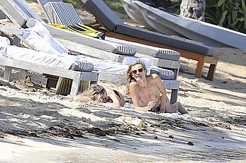 Edita Vilkeviciute sunbathing topless in St Barts