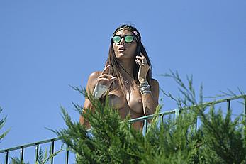 Elisabetta Gregoraci caught topless on a balcony in Porto Cervo