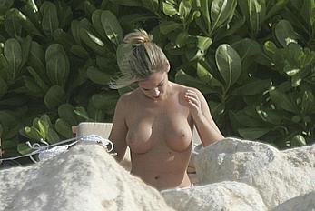 Emily Oldfield changing on a beach shows her nude boobs and ass