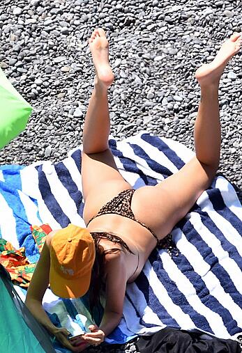 Emily Ratajkowski tit slip in a bikini in Italy