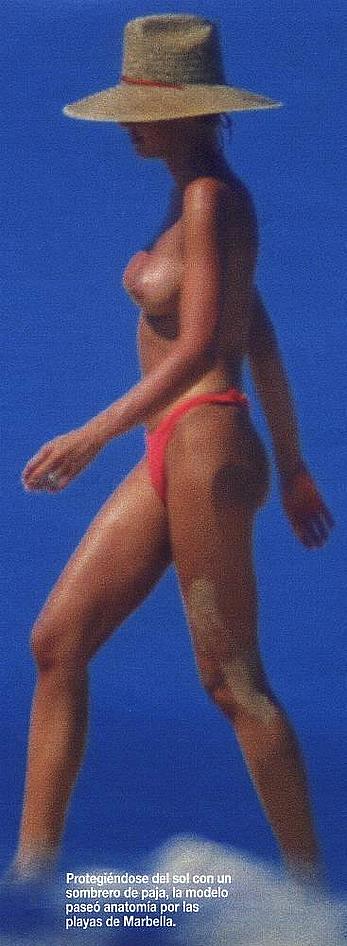 Esther Arroyo topless in red bikini pants on a beach