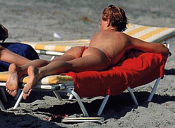 Esther Arroyo topless in red bikini pants on a beach