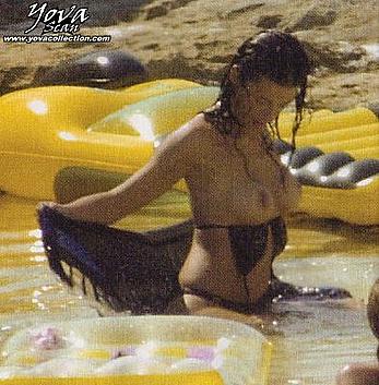 Eva Paz sunbathing topless on a beach