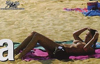 Eva Paz sunbathing topless on a beach