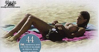 Eva Paz sunbathing topless on a beach