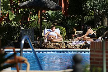 Gemma Atkinson bottom of boob in bikini poolside in Marbella