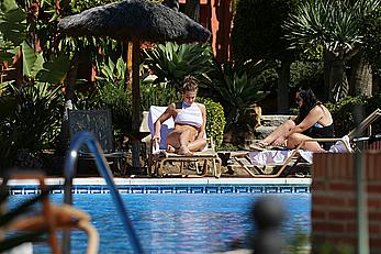 Gemma Atkinson bottom of boob in bikini poolside in Marbella