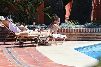 Gemma Atkinson bottom of boob in bikini poolside in Marbella