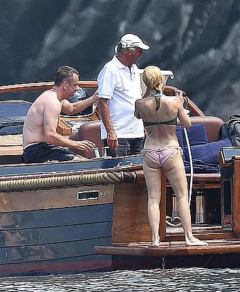 Gillian Anderson flashes her tit and ass crack while removing her bikini on holiday in Italy