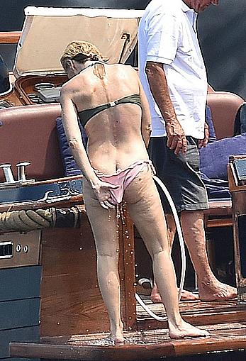 Gillian Anderson flashes her tit and ass crack while removing her bikini on holiday in Italy