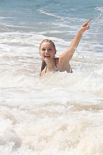 Greer Grammer wearing a bikini on a beach