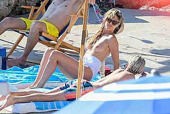 Heidi Klum sunbathing topless in Capri