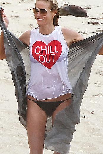 Heidi Klum in wet shirt on the beach in St.Barths