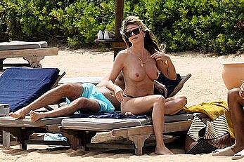 Heidi Klum in bikini and topless on a beach in Sardinia