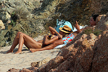 Supermodel Heidi Klum sunbathing topless at a beach in Italy