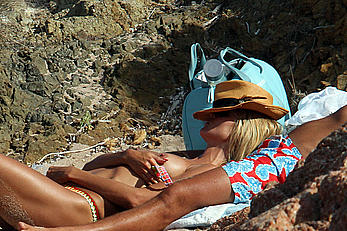 Supermodel Heidi Klum sunbathing topless at a beach in Italy