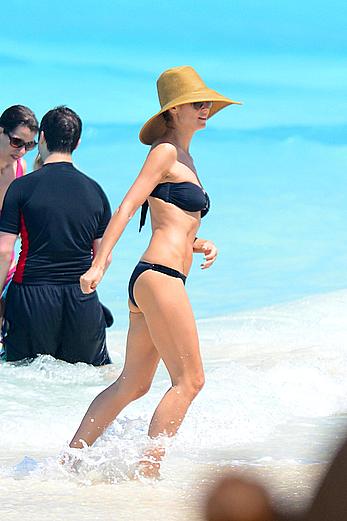 Heidi Klum wearing black bikini at a beach in the Bahamas