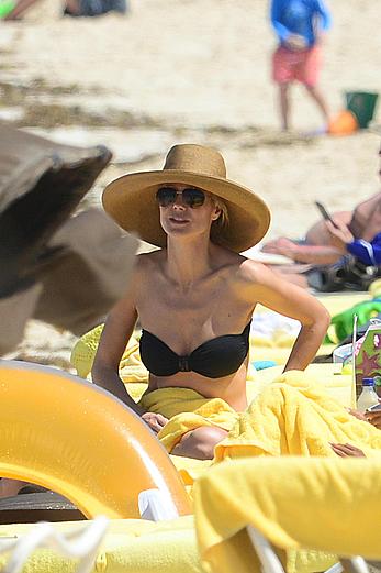 Heidi Klum wearing black bikini at a beach in the Bahamas