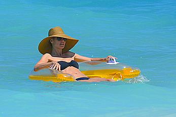 Heidi Klum wearing black bikini at a beach in the Bahamas