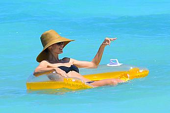 Heidi Klum wearing black bikini at a beach in the Bahamas