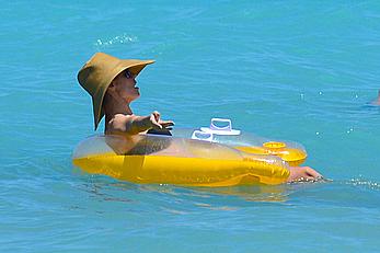 Heidi Klum wearing black bikini at a beach in the Bahamas