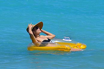 Heidi Klum wearing black bikini at a beach in the Bahamas