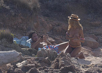 Supermodel Heidi Klum sunbathing topless at a beach in Italy