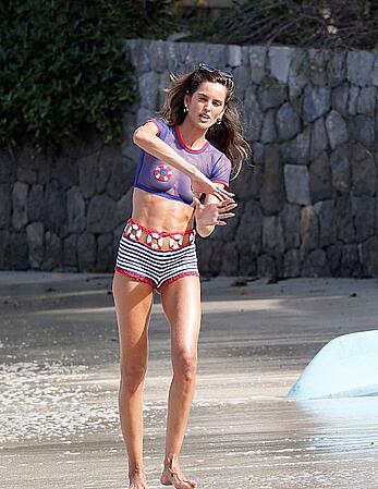 Izabel Goulart braless with pasties in a see through top in St Bart’s