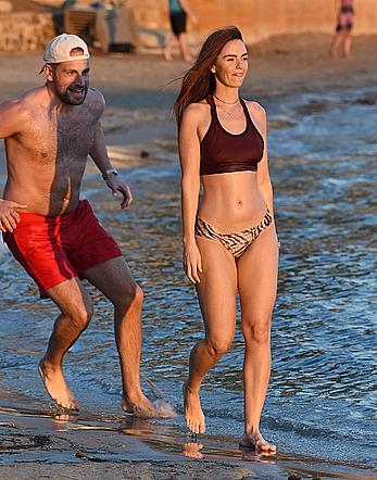 Jennifer Metcalfe pokies in wet bikini on a beach in Ibiza