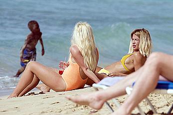 Jessica Woodley pokies in yellow bikini on the beach in Barbados