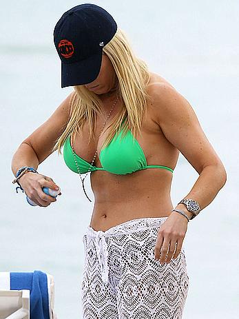 Jill Martin shows cleavage in green bikini