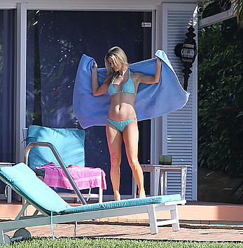 Joanna Krupa enjoying a sunny day in blue bikini at the pool in Miami Beach