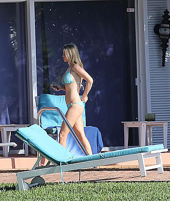 Joanna Krupa enjoying a sunny day in blue bikini at the pool in Miami Beach