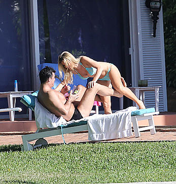 Joanna Krupa enjoying a sunny day in blue bikini at the pool in Miami Beach