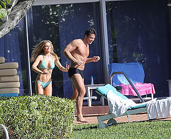 Joanna Krupa enjoying a sunny day in blue bikini at the pool in Miami Beach