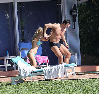 Joanna Krupa enjoying a sunny day in blue bikini at the pool in Miami Beach