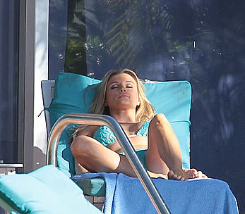 Joanna Krupa enjoying a sunny day in blue bikini at the pool in Miami Beach