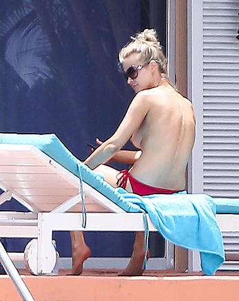 Joanna Krupa topless at a pool in Miami