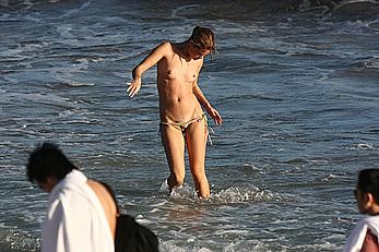 Julie Ordon topless on a beach