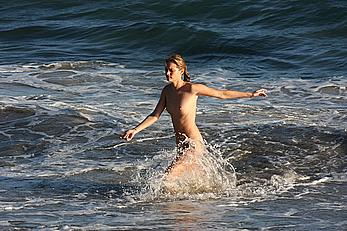 Julie Ordon topless on a beach