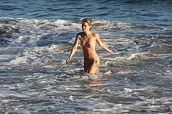 Julie Ordon topless on a beach