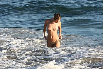 Julie Ordon topless on a beach