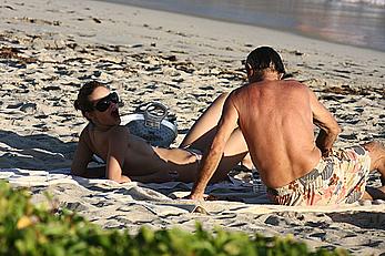 Julie Ordon topless on a beach