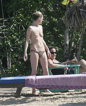 Supermodel Kate Moss sunbathing topless